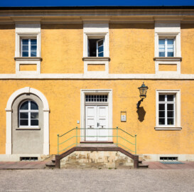 Schloss Bruchsal - Südliche Orangerie / Kavaliersbau - Von Außen / Von Osten - Blick auf die nördliche Seite der Ostfassade mit dem Treppeneingang (aufgenommen im Juli 2018, am späten Vormittag)