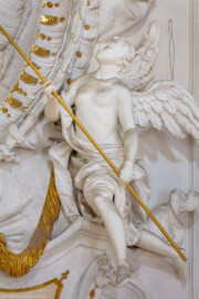 Schloss Bruchsal - Hauptbau - Beletage - Kuppelsaal - Stuckdraperie, oberhalb des Durchgangs zum Fürstensaal - Rechter Engel mit bischöflichen Insignien der geistlichen Macht (ursprünglich geschaffen von Johann Michael Feichtmayr) (aufgenommen im Juli 2018, am  Nachmittag)