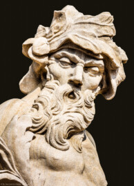 Schloss Bruchsal - Schlossgarten - Hauptachse, Nordseite, 3. Skulptur von Osten - Kopf der Skulptur "Das Wasser" aus dem Skulpturenensemble "Vier Elemente" (Kopie von Hans Volker Dursy; Original gehauen 1761 von Joachim Günther, befindet sich im Gartensaal des Hauptbaus) (aufgenommen im September 2018, am späten Nachmittag)
