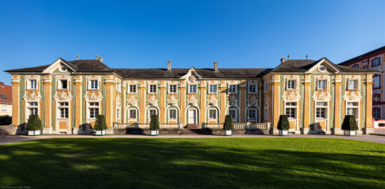 Schloss Bruchsal - Nördliche Orangerie / Nebendienstdienerbau - Von Außen / Von Westen - Blick von der Schlossterrasse auf die Westfassade der Orangerie (ursprünglich gemalt von Giovanni Francesco Marchini, zwischen 1732 und 1737, restauriert von Josef Mariano Kitschker, zwischen 1900 und 1910, erneut restauriert von Klaus Siller (Fassadenmalerei) und  Walter Maschke (Allegorien), 1976) (aufgenommen im Oktober 2018, am späten Nachmittag)