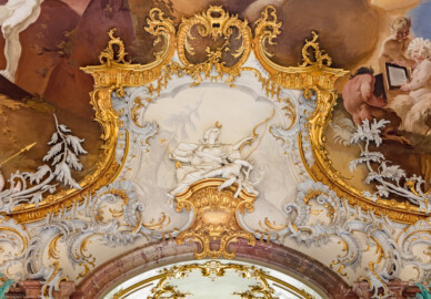 Schloss Bruchsal - Hauptbau / Corps de Logis - Beletage - Marmorsaal / Kaisersaal - Oberhalb der Tür zum Balkon - Von Osten - Blick vom Durchgang zum Kuppelsaal nach Westen in den unteren Teil des Gewölbes (Deckenbild ursprünglich von Johannes Zick, rekonstruiert von Wolfram Köberl, 1969 bis 1973; Stuckaturen ursprünglich von Johann Michael Feichtmayr) (aufgenommen im Mai 2019, am frühen Nachmittag)