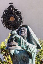 Waghäusel - Wallfahrtskirche / Kloster - Außen - Nordseite, östlich der Klosterpforte - Von Westen - Blick auf die Skulptur der Hl. Klara (der Patronin des Klosters), eine Monstranz vor sich her tragend (aufgenommen im April 2020, am späten Nachmittag)