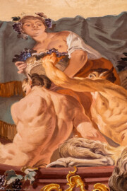 Schloss Bruchsal - Hauptbau / Corps de Logis - Beletage - Fürstensaal - Decke, äußere Zone, Südostecke - Ausschnitt aus der südöstlichen äußeren Zone - Ausschnitt aus der Darstellung des Weinbaus, ein wichtiger Wirtschaftszweig Bruchsals - Mittig oben (Mann/Frau mit Weinlaubkrone und Korb mit Weintrauben): Darstellung des griechischen / römischen Weingottes Dionysos / Bacchus; mittig unten (mannartige Figuren): Darstellung von Satyrn, mit Bocks-Beinen und -Ohren (Deckenfresko urspünglich gemalt 1751 von Johannes Zick, originalgetreu rekonstruiert 1966 bis 1969 von Wolfram Köberl) (aufgenommen im Mai 2020, am späten Vormittag) Schloss Bruchsal - Hauptbau / Corps de Logis - Beletage - Fürstensaal - Decke, äußere Zone, Südostecke - Ausschnitt aus der südöstlichen äußeren Zone - Ausschnitt aus der Darstellung des Weinbaus, ein wichtiger Wirtschaftszweig Bruchsals - Mittig oben (Mann/Frau mit Weinlaubkrone und Korb mit Weintrauben): Darstellung des griechischen / römischen Weingottes Dionysos / Bacchus; mittig unten (mannartige Figuren): Darstellung von Satyrn, mit Bocks-Beinen und -Ohren (Deckenfresko urspünglich gemalt 1751 von Johannes Zick, originalgetreu rekonstruiert 1966 bis 1969 von Wolfram Köberl) (aufgenommen im Mai 2020, am späten Vormittag)