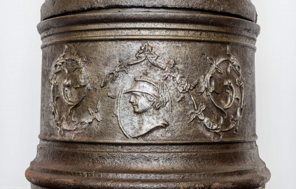 Schloss Bruchsal - Hauptbau / Corps de Logis - Von innen - Beletage - Winterspeisezimmer - Westseite, Mitte - Blick auf das unterste Segment des Stubenofens aus Gusseisen (sog. Kanonenofen) (beschädigt beim Brand 1945, wohl nach 2000 wiederhergestellt, u.a. durch Restauratorin Magdalena Baur und der Kunstschmiede Peter Klink aus Pfullendorf) (aufgenommen im März 2021, am frühen Nachmittag) Schloss Bruchsal - Hauptbau / Corps de Logis - Von innen - Beletage - Winterspeisezimmer - Westseite, Mitte - Blick auf das unterste Segment des Stubenofens aus Gusseisen (sog. Kanonenofen) (beschädigt beim Brand 1945, wohl nach 2000 wiederhergestellt, u.a. durch Restauratorin Magdalena Baur und der Kunstschmiede Peter Klink aus Pfullendorf) (aufgenommen im März 2021, am frühen Nachmittag)