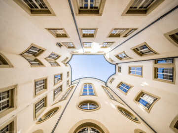 Schloss Bruchsal - Hauptbau / Corps de Logis - Von innen - Nördlicher Innenhof - Blick vom Boden des Innenhofs nach oben, unterhalb der Mitte die drei hohen nördlichen Bogenfenster des Kuppelsaals, darunter die drei Ovalfenster der Haupttreppe, darunter die Tür zur Grotte (unten ist Süden, oben Norden) (aufgenommen im März 2021, am frühen Nachmittag) Schloss Bruchsal - Hauptbau / Corps de Logis - Von innen - Nördlicher Innenhof - Blick vom Boden des Innenhofs nach oben, unterhalb der Mitte die drei hohen nördlichen Bogenfenster des Kuppelsaals, darunter die drei Ovalfenster der Haupttreppe, darunter die Tür zur Grotte (unten ist Süden, oben Norden) (aufgenommen im März 2021, am frühen Nachmittag)