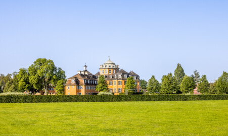 Waghäusel - Eremitage - Von Außen - Von Norden - Blick auf das Gesamt-Ensemble: in der Mitte der Zentralbau, links der nordöstliche Kavalierspavillon (der "Gardebau"), links davon hinter den Bäumen der südöstliche Kavalierspavillon (der "Küchenbau") (aufgenommen im Juli 2021, am Vormittag)