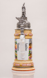 Städtisches Museum Bruchsal - Schloss Bruchsal - Hauptbau / Corps de Logis - Nördlicher Raum, Bereich Gelbe Dragoner - Rückansicht eines Reservistenkrugs des ehemaligen Dragoners Bloch (Dienstzeit 1909-1912) (Bildnis unterhalb der Mitte: Friedrich II., Großherzog von Baden (reg. 1907-1918); Inschriften von oben nach unten: Deckel: Mitte "Reserve hat Ruh", links "Ihr Brüder stosst die Glässer an - es lebe der Reservemann", rechts "Der treu gedient hat seine Zeit - dem sei ein volles Glas geweiht"; Krug ganz oben, Mitte: "Stolz zu Roß die Cavallerie auf dem Posten spät und früh"; darunter: "Reservist Bloch"; darunter, Mitte: "So lang ich leben werde vergessen werd ichs nie - Ich bin ein Lanzenreiter der deutschen Cavallerie", darunter "Sieg oder Tod", darunter "Ob zu Fuß oder zu Pferd - Oder hinter der Kanone - Schützen wir der Heimat Herd - Und dem Fürsten seine Krone"; links: "Wenn Dragoner patroullieren - Und den stärksten Feind aufspüren - Aufklären tun sie das Gelände - Der Feind fällt ihnen in die Hände"; rechts: "Die Trompete ruft zum Scheiden - Drum mein Mädchen lebe wohl" und "Des Reservisten letzte Einquartierung" und "Behüt dich Gott, es wär so schön gewesen - Behüt dich Gott, es hat nicht sollen sein"; darunter links und rechts "Erinnerung an meine Dienstzeit"; darunter Mitte "3. Esk. 2. Bad. Drag. Regt. Nr 21. Bruchsal. 1909-12."; Rückseite: links: "Reservist Bloch Blumhofer Dinger Dinkel Gerstner Gräble Häfele Hoffmann Melin Jakobi Klump Kramb Lotz", rechts: "Reservist Mantel Renz Michils Schuster Schwarz Schreiber Steinmann Stiebing Stoffel Weigel Weis Ziegler"; Inv.Nr. 2008.1) (aufgenommen im September 2021, am frühen Nachmittag) Städtisches Museum Bruchsal - Schloss Bruchsal - Hauptbau / Corps de Logis - Nördlicher Raum, Bereich Gelbe Dragoner - Rückansicht eines Reservistenkrugs des ehemaligen Dragoners Bloch (Dienstzeit 1909-1912) (Bildnis unterhalb der Mitte: Friedrich II., Großherzog von Baden (reg. 1907-1918); Inschriften von oben nach unten: Deckel: Mitte "Reserve hat Ruh", links "Ihr Brüder stosst die Glässer an - es lebe der Reservemann", rechts "Der treu gedient hat seine Zeit - dem sei ein volles Glas geweiht"; Krug ganz oben, Mitte: "Stolz zu Roß die Cavallerie auf dem Posten spät und früh"; darunter: "Reservist Bloch"; darunter, Mitte: "So lang ich leben werde vergessen werd ichs nie - Ich bin ein Lanzenreiter der deutschen Cavallerie", darunter "Sieg oder Tod", darunter "Ob zu Fuß oder zu Pferd - Oder hinter der Kanone - Schützen wir der Heimat Herd - Und dem Fürsten seine Krone"; links: "Wenn Dragoner patroullieren - Und den stärksten Feind aufspüren - Aufklären tun sie das Gelände - Der Feind fällt ihnen in die Hände"; rechts: "Die Trompete ruft zum Scheiden - Drum mein Mädchen lebe wohl" und "Des Reservisten letzte Einquartierung" und "Behüt dich Gott, es wär so schön gewesen - Behüt dich Gott, es hat nicht sollen sein"; darunter links und rechts "Erinnerung an meine Dienstzeit"; darunter Mitte "3. Esk. 2. Bad. Drag. Regt. Nr 21. Bruchsal. 1909-12."; Rückseite: links: "Reservist Bloch Blumhofer Dinger Dinkel Gerstner Gräble Häfele Hoffmann Melin Jakobi Klump Kramb Lotz", rechts: "Reservist Mantel Renz Michils Schuster Schwarz Schreiber Steinmann Stiebing Stoffel Weigel Weis Ziegler"; Inv.Nr. 2008.1) (aufgenommen im September 2021, am frühen Nachmittag)