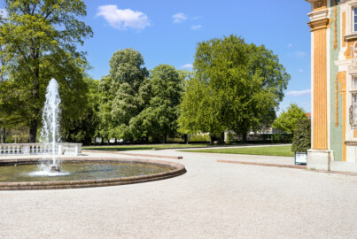 Schloss Bruchsal - Schlossterrasse, Nordseite - Von Südost - Blick auf die nördliche Terrasse und den Garten, rechts die Südwestecke der Nördlichen Orangerie (aufgenommen im April 2022, am Nachmittag)