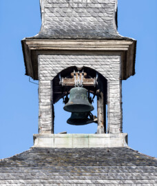 Schloss und Schlossgarten Schwetzingen - Schloss - Mittelbau - Südturm - Hofseite - Von Osten - Blick vom Ehrenhof nach oben auf die beiden Uhrschlagglocken im Glockenstuhl des Südturms (Glockengießer: Johann und Andreas Schneidewind / Frankfurt am Main, Gussjahr: 1724; größere / kleinere Glocke: östlich / westlich, Durchmesser 68 cm / 55 cm, Nominal/Schlagton: d'' / f'', Referenznummer (Deutscher Glockenatlas, Bd. 4, Baden, Seite 577): 1891 / 1892; Plattform unter den Glocken: nur ca. 70 x 70 cm; Aufhängung: mittels Holzjochen mit Bandeisenbeschlägen, wohl um 2010 erneuert; Uhrschlaghämmer: elektrisch betrieben und elektronisch gesteuert; Schläge: Stunden- und Viertelstundenschläge) (aufgenommen im Juli 2023, am Vormittag)
