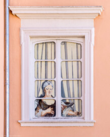 Schloss und Schlossgarten Schwetzingen - Schloss - Mittelbau - Südlicher Eckpavillon - Von Norden - Blick auf das Nordfenster im 1. Obergeschoss des südlichen Eckpavillons; dahinter befand sich das Grosse Cabinet der Kurfürstin ; Elisabeth Auguste (eine gemalte Figur) blickt auf die Terrasse herunter (Mittelbau: Länge Westseite ca. 45 Meter, Breite Süd-/Nordseite ca. 38 Meter; Wiederaufbau / Erweiterung: 1698-1717; Architekt: Johann Adam Breunig) (aufgenommen im August 2023, um die Mittagszeit)