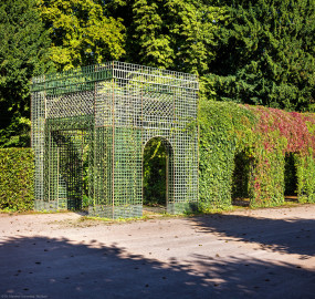 Schloss und Schlossgarten Schwetzingen - Garten - Kreisparterre - Nördlicher Laubengang, Südwestende - Von Südost - Blick nach Nordwesten auf einen Ausschnitt des nördlichen Laubengangs (Berceaux de Treillage) mit portalartigem Eingang; die Laubengänge sind mit wildem Wein und blühenden Kletterpflanzen bepflanzt (aufgenommen im August 2023, am späten Vormittag) Schloss und Schlossgarten Schwetzingen - Garten - Kreisparterre - Nördlicher Laubengang, Südwestende - Von Südost - Blick nach Nordwesten auf einen Ausschnitt des nördlichen Laubengangs (Berceaux de Treillage) mit portalartigem Eingang; die Laubengänge sind mit wildem Wein und blühenden Kletterpflanzen bepflanzt (aufgenommen im August 2023, am späten Vormittag)