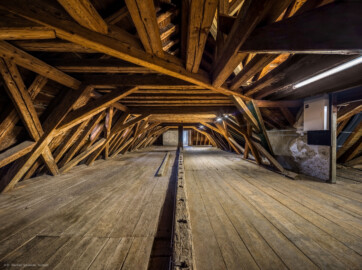 Schloss und Schlossgarten Schwetzingen - Schloss - Mittelbau - Von innen - Dachstuhl, Nordseite - Von Westen - Blick nach Osten in den Dachstuhl in Richtung Nordturm; ganz hinten in der Mitte die Tür zum obersten Raum des Nordturms; ganz hinten rechts (außerhalb des Bildes) der Aufgang zum Dachstuhl; vorne rechts der Übergang zum mittleren Teil des Dachstuhls (Mittelbau: Länge Westseite ca. 45 Meter, Breite Süd-/Nordseite ca. 38 Meter; Wiederaufbau / Erweiterung: 1698-1717; Architekten: Johann Adam Breunig, Simon Sarto) (aufgenommen im Oktober 2023, um die Mittagszeit) Schloss und Schlossgarten Schwetzingen - Schloss - Mittelbau - Von innen - Dachstuhl, Nordseite - Von Westen - Blick nach Osten in den Dachstuhl in Richtung Nordturm; ganz hinten in der Mitte die Tür zum obersten Raum des Nordturms; ganz hinten rechts (außerhalb des Bildes) der Aufgang zum Dachstuhl; vorne rechts der Übergang zum mittleren Teil des Dachstuhls (Mittelbau: Länge Westseite ca. 45 Meter, Breite Süd-/Nordseite ca. 38 Meter; Wiederaufbau / Erweiterung: 1698-1717; Architekten: Johann Adam Breunig, Simon Sarto) (aufgenommen im Oktober 2023, um die Mittagszeit)