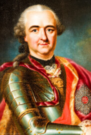 Schloss und Schlossgarten Schwetzingen - Schloss - Mittelbau - Von innen - 1. Obergeschoss - Appartment des Kurfürsten - Erstes Vorzimmer - Westwand, links der Tür zum zweiten Vorzimmer - Ausschnitt aus dem Porträt von Kurfürst Carl Theodor (1724-1799, reg. 1742-1799); gekleidet in einer Paraderüstung mit umgehängtem Mantel; an seiner linken Brust ein Bruststern des Ordens des Heiligen Hubertus (kurz Hubertusorden) mit der Abkürzung der Ordensdevise "In Treue fest" als Inschrift; mitten auf der Brust der zum Hausritterorden vom Heiligen Georg (kurz Georgsorden) gehörende Löwenkopf (Maler: Heinrich Carl Brandt (1724-1787); Datierung: um 1767) (aufgenommen im Dezember 2023, am frühen Nachmittag) Schloss und Schlossgarten Schwetzingen - Schloss - Mittelbau - Von innen - 1. Obergeschoss - Appartment des Kurfürsten - Erstes Vorzimmer - Westwand, links der Tür zum zweiten Vorzimmer - Ausschnitt aus dem Porträt von Kurfürst Carl Theodor (1724-1799, reg. 1742-1799); gekleidet in einer Paraderüstung mit umgehängtem Mantel; an seiner linken Brust ein Bruststern des Ordens des Heiligen Hubertus (kurz Hubertusorden) mit der Abkürzung der Ordensdevise "In Treue fest" als Inschrift; mitten auf der Brust der zum Hausritterorden vom Heiligen Georg (kurz Georgsorden) gehörende Löwenkopf (Maler: Heinrich Carl Brandt (1724-1787); Datierung: um 1767) (aufgenommen im Dezember 2023, am frühen Nachmittag)