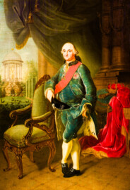 Schloss und Schlossgarten Schwetzingen - Schloss - Mittelbau - Von innen - 1. Obergeschoss - Appartment des Kurfürsten - Kabinett - Südwand, westliche Seite - Porträt von Kurfürst Carl Theodor (1724-1799, reg. 1742-1799); gekleidet in einen grünen Samtanzug, gegen einen Sessel gelehnt; umgeben von herrschaftlichen Würdezeichen: dem Schärpenband und dem Bruststern des Ordens des Heiligen Hubertus (kurz Hubertusorden) mit der Abkürzung der Ordensdevise "In Treue fest" als Inschrift; auf der Brust der Orden vom Pfälzer Löwen (kurz Löwenorden), gestiftet 1768 von Carl Theodor einen Tag nach Vollendung seines 25-jährigen Regierungsjubiläums; rechts der rote Kurhut; links im Hintergrund der Apollo-Tempel des Schwetzinger Schlossgartens; (Maler: Johann Peter Hoffmeister (1740-1772), Datierung: um 1770) (aufgenommen im Dezember 2023, am späten Nachmittag) Schloss und Schlossgarten Schwetzingen - Schloss - Mittelbau - Von innen - 1. Obergeschoss - Appartment des Kurfürsten - Kabinett - Südwand, westliche Seite - Porträt von Kurfürst Carl Theodor (1724-1799, reg. 1742-1799); gekleidet in einen grünen Samtanzug, gegen einen Sessel gelehnt; umgeben von herrschaftlichen Würdezeichen: dem Schärpenband und dem Bruststern des Ordens des Heiligen Hubertus (kurz Hubertusorden) mit der Abkürzung der Ordensdevise "In Treue fest" als Inschrift; auf der Brust der Orden vom Pfälzer Löwen (kurz Löwenorden), gestiftet 1768 von Carl Theodor einen Tag nach Vollendung seines 25-jährigen Regierungsjubiläums; rechts der rote Kurhut; links im Hintergrund der Apollo-Tempel des Schwetzinger Schlossgartens; (Maler: Johann Peter Hoffmeister (1740-1772), Datierung: um 1770) (aufgenommen im Dezember 2023, am späten Nachmittag)