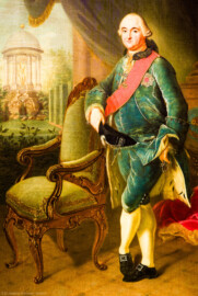 Schloss und Schlossgarten Schwetzingen - Schloss - Mittelbau - Von innen - 1. Obergeschoss - Appartment des Kurfürsten - Kabinett - Südwand, westliche Seite - Ausschnitt aus dem Porträt von Kurfürst Carl Theodor (1724-1799, reg. 1742-1799); gekleidet in einen grünen Samtanzug, gegen einen Sessel gelehnt; umgeben von herrschaftlichen Würdezeichen: dem Schärpenband und dem Bruststern des Ordens des Heiligen Hubertus (kurz Hubertusorden) mit der Abkürzung der Ordensdevise "In Treue fest" als Inschrift; auf der Brust der Orden vom Pfälzer Löwen (kurz Löwenorden), gestiftet 1768 von Carl Theodor einen Tag nach Vollendung seines 25-jährigen Regierungsjubiläums; links im Hintergrund der Apollo-Tempel des Schwetzinger Schlossgartens (Maler: Johann Peter Hoffmeister (1740-1772), Datierung: um 1770) (aufgenommen im Januar 2024, am späten Vormittag) Schloss und Schlossgarten Schwetzingen - Schloss - Mittelbau - Von innen - 1. Obergeschoss - Appartment des Kurfürsten - Kabinett - Südwand, westliche Seite - Ausschnitt aus dem Porträt von Kurfürst Carl Theodor (1724-1799, reg. 1742-1799); gekleidet in einen grünen Samtanzug, gegen einen Sessel gelehnt; umgeben von herrschaftlichen Würdezeichen: dem Schärpenband und dem Bruststern des Ordens des Heiligen Hubertus (kurz Hubertusorden) mit der Abkürzung der Ordensdevise "In Treue fest" als Inschrift; auf der Brust der Orden vom Pfälzer Löwen (kurz Löwenorden), gestiftet 1768 von Carl Theodor einen Tag nach Vollendung seines 25-jährigen Regierungsjubiläums; links im Hintergrund der Apollo-Tempel des Schwetzinger Schlossgartens (Maler: Johann Peter Hoffmeister (1740-1772), Datierung: um 1770) (aufgenommen im Januar 2024, am späten Vormittag)