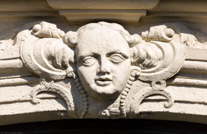 Schloss und Schlossgarten Schwetzingen - Garten - Gesandtenhaus (ehemaliges Prinzenhaus) / Amtsgericht - Von Südost - Blick auf das Kopfrelief mit Rocaille-Verzierung am Türrahmen des Eingangs zum Gesandtenhaus (Wohnungen für Angehörige der kurfürstlichen Familie, ausländische Besucher, Nicolas de Pigage (1723-1796), Friedrich Ludwig Skell (1750-1823), Johann Michael Zeyher (1770-1843), Sterbeort von Johann Peter Hebel (1760-1826), ab 1805 Amtsgericht) (Bau: Länge x Breite: ca. 40 x 17 Meter; Bauzeit: um 1723; Architekt: unbekannt) (aufgenommen im Juli 2024, am späten Vormittag) Schloss und Schlossgarten Schwetzingen - Garten - Gesandtenhaus (ehemaliges Prinzenhaus) / Amtsgericht - Von Südost - Blick auf das Kopfrelief mit Rocaille-Verzierung am Türrahmen des Eingangs zum Gesandtenhaus (Wohnungen für Angehörige der kurfürstlichen Familie, ausländische Besucher, Nicolas de Pigage (1723-1796), Friedrich Ludwig Skell (1750-1823), Johann Michael Zeyher (1770-1843), Sterbeort von Johann Peter Hebel (1760-1826), ab 1805 Amtsgericht) (Bau: Länge x Breite: ca. 40 x 17 Meter; Bauzeit: um 1723; Architekt: unbekannt) (aufgenommen im Juli 2024, am späten Vormittag)