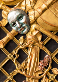 Schloss und Schlossgarten Schwetzingen - Garten - Schlosstheater - Von innen - Proszenium, Südseite - Blick auf eine Maske sowie auf einen Blätter- und Blütenkranz auf einem Gitterwerk im mittleren Teil des südlichen Proszeniums (Gesamter Bau: Länge x Breite: ca. 62 x 35 Meter; Architekt: Nicolas de Pigage (1723-1796); Bauzeit: 1752-1753, Erweiterung 1762, Sanierung: 1937, Renovierung: 1952, Generalsanierung / Umbau 1971-1974, Restaurierung: 1999-2005) (aufgenommen im Dezember 2024, um die Mittagszeit)