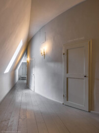 Schloss und Schlossgarten Schwetzingen - Garten - Schlosstheater - Von innen - 2. Obergeschoss (Rang), südliches Foyer - Von Südost - Blick von der südöstlichen Ecke des Foyers bzw. dem Eingang im südöstlichen Treppenhaus nach Westen in das Foyer; rechts die Rückwand des hufeisenförmigen Zuschauerraums mit den Eingängen zum Rang; die Tür im Hintergrund führt in die untere Ebene des historischen Dachstuhls über dem Zuschauerraum (Gesamter Bau: Länge x Breite: ca. 62 x 35 Meter; Architekt: Nicolas de Pigage (1723-1796); Bauzeit: 1752-1753, Erweiterung 1762, Sanierung: 1937, Renovierung: 1952, Generalsanierung / Umbau 1971-1974, Restaurierung: 1999-2005) (aufgenommen im September 2025, am Nachmittag) Schloss und Schlossgarten Schwetzingen - Garten - Schlosstheater - Von innen - 2. Obergeschoss (Rang), südliches Foyer - Von Südost - Blick von der südöstlichen Ecke des Foyers bzw. dem Eingang im südöstlichen Treppenhaus nach Westen in das Foyer; rechts die Rückwand des hufeisenförmigen Zuschauerraums mit den Eingängen zum Rang; die Tür im Hintergrund führt in die untere Ebene des historischen Dachstuhls über dem Zuschauerraum (Gesamter Bau: Länge x Breite: ca. 62 x 35 Meter; Architekt: Nicolas de Pigage (1723-1796); Bauzeit: 1752-1753, Erweiterung 1762, Sanierung: 1937, Renovierung: 1952, Generalsanierung / Umbau 1971-1974, Restaurierung: 1999-2005) (aufgenommen im September 2025, am Nachmittag)