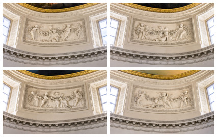 Schloss und Schlossgarten Schwetzingen - Garten - Badhaus - Von innen - Ovalsaal - Puttenfriese - Vier Felder im Tambour: spielende Putti, verbunden durch eine Blumen- und Fruchtgirlande, eingebettet in ein Feld mit Tropfenstuck, umgeben von einem glatten Rahmen; v.l.n.r., v.o.n.u.: nordwestliches, nordöstliches, südöstliches, südwestliches Feld (Stuckateur: Giuseppe Antonio Pozzi (1732–1811)) (Gesamter Bau: Länge x Breite ca. 18 x 14 Meter, Höhe ca. 10 Meter; Architekt: Nicolas de Pigage (1723-1796); Bauzeit: 1768-1772; Gesamtinstandsetzung innen und außen: 1999-2006) (aufgenommen im Oktober 2025, am Nachmittag) Schloss und Schlossgarten Schwetzingen - Garten - Badhaus - Von innen - Ovalsaal - Puttenfriese - Vier Felder im Tambour: spielende Putti, verbunden durch eine Blumen- und Fruchtgirlande, eingebettet in ein Feld mit Tropfenstuck, umgeben von einem glatten Rahmen; v.l.n.r., v.o.n.u.: nordwestliches, nordöstliches, südöstliches, südwestliches Feld (Stuckateur: Giuseppe Antonio Pozzi (1732–1811)) (Gesamter Bau: Länge x Breite ca. 18 x 14 Meter, Höhe ca. 10 Meter; Architekt: Nicolas de Pigage (1723-1796); Bauzeit: 1768-1772; Gesamtinstandsetzung innen und außen: 1999-2006) (aufgenommen im Oktober 2025, am Nachmittag)