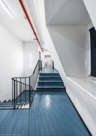 Schloss und Schlossgarten Schwetzingen - Garten - Schlosstheater - Von innen - Westliches Treppenhaus - 2. Obergeschoss - Von Norden - Blick vom nördlichen Treppenabsatz im 2. Obergeschoss nach Süden; die vier Stufen rechts führen auf ein Zwischengeschoss zwischen dem 2. und 3. Obergeschoss; die Tür links der Bildmitte am Ende des Geländers führt in das 3. Obergeschoss bzw. den Rollenboden / Schnürboden; die Tür rechts der Bildmitte führt (nach rechts, nicht sichtbar) in Büroräume und nach hinten zur Tür zu den Garderoben (Gesamter Bau: Länge x Breite: ca. 62 x 35 Meter; Architekt: Nicolas de Pigage (1723-1796); Bauzeit: 1752-1753, Erweiterung 1762, Sanierung: 1937, Renovierung: 1952, Generalsanierung / Umbau 1971-1974, Restaurierung: 1999-2005) (aufgenommen im Oktober 2025, am frühen Nachmittag) Schloss und Schlossgarten Schwetzingen - Garten - Schlosstheater - Von innen - Westliches Treppenhaus - 2. Obergeschoss - Von Norden - Blick vom nördlichen Treppenabsatz im 2. Obergeschoss nach Süden; die vier Stufen rechts führen auf ein Zwischengeschoss zwischen dem 2. und 3. Obergeschoss; die Tür links der Bildmitte am Ende des Geländers führt in das 3. Obergeschoss bzw. den Rollenboden / Schnürboden; die Tür rechts der Bildmitte führt (nach rechts, nicht sichtbar) in Büroräume und nach hinten zur Tür zu den Garderoben (Gesamter Bau: Länge x Breite: ca. 62 x 35 Meter; Architekt: Nicolas de Pigage (1723-1796); Bauzeit: 1752-1753, Erweiterung 1762, Sanierung: 1937, Renovierung: 1952, Generalsanierung / Umbau 1971-1974, Restaurierung: 1999-2005) (aufgenommen im Oktober 2025, am frühen Nachmittag)