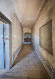 Schloss und Schlossgarten Schwetzingen - Schloss - Mittelbau - Von innen - 3. Obergeschoss - Nördlicher Gang - Von Osten - Blick von der Tür nach Westen in den Gang; links die Tür zum Raum 235, rechts ein Wandschrank; ganz hinten im westlichen Gang demontierte Bauteile (aufgenommen im März 2026, am späten Vormittag) Schloss und Schlossgarten Schwetzingen - Schloss - Mittelbau - Von innen - 3. Obergeschoss - Nördlicher Gang - Von Osten - Blick von der Tür nach Westen in den Gang; links die Tür zum Raum 235, rechts ein Wandschrank; ganz hinten im westlichen Gang demontierte Bauteile (aufgenommen im März 2026, am späten Vormittag)