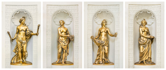 Schloss und Schlossgarten Schwetzingen - Garten - Badhaus - Von innen - Ovalsaal - Vier Wandnischen, (v.l.n.r.) Südost, Südwest, Nordwest, Nordost - Blick auf die vier Frauenfiguren in den vier Wandnischen; Begleiterinnen der Aurora, für den Tagesablauf stehend (Bildhauer: Peter Anton von Verschaffelt (1710-1793), Datierung: um 1779, Material: Sandstein, bronziert, Höhe 150 cm) (Gesamter Bau: Länge x Breite ca. 18 x 14 Meter, Höhe ca. 10 Meter; Architekt: Nicolas de Pigage (1723-1796); Bauzeit: 1768-1772; Gesamtinstandsetzung innen und außen: 1999-2006) (aufgenommen im Juli 2026, am frühen Nachmittag)