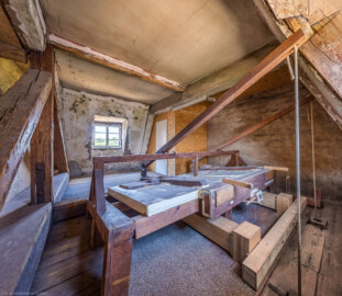 Schloss und Schlossgarten Schwetzingen - Schloss - Nordflügel, Querbau - Dachgeschoss - Raum der Windanlage, oberhalb der Orgel - Von Osten  - Blick in den Raum mit der historischen mechanischen Windanlage der Orgel; durch Ziehen an den Seilen (im Raum neben der Orgel unterhalb) erzeugt das Windwerk Druckluft (den Orgelwind), die zu den Orgelpfeifen geleitet wird und dort Töne erzeugen kann  (Orgelbauer: Andreas Ubhauser (1765-1822), Bauzeit: 1806, umfassende Restaurierung: 1980-1982, Originalteile: ca. 90 Prozent;  Windwerk: Schleifladen und elektrisches Gebläse, Register: 10, Manuale: 1 / C-f3, Pedale: 1 / C-f0; Orgelpfeifen aus Zinn, Tastatur aus Ebenholz) (aufgenommen im Juli 2026, am frühen Nachmittag)