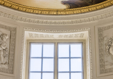 Schloss und Schlossgarten Schwetzingen - Garten - Badhaus - Von innen - Ovalsaal - Friese an und unterhalb der Decke - Von Süden - Blick nach oben auf das nördliche Fenster und die Friese darüber; v.u.n.o.: am Fenster Perlstab und Eierstab, darüber Perlstab, Blattfries, Blattstab, an der Decke ein Zinnenfries, ein vergoldeten Eichenlaubkranz aus Holz, ein Perlstab und ein Blattstab (Stuckateur: Giuseppe Antonio Pozzi (1732–1811)) (Gesamter Bau: Länge x Breite ca. 18 x 14 Meter, Höhe ca. 10 Meter; Architekt: Nicolas de Pigage (1723-1796); Bauzeit: 1768-1772; Gesamtinstandsetzung innen und außen: 1999-2006) (aufgenommen im Juli 2026, am frühen Nachmittag)