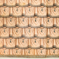 Schloss und Schlossgarten Schwetzingen - Schloss - Mittelbau - Von innen - 2. Obergeschoss - Toilettekabinett der Reichsgräfin von Hochberg - Nordwand - Ausschnitt aus der Zuber-Papiertapete; Imitation einer schweren Draperie aus braunem Stoff mit antikisierenden Bordüren; rechts eine (kaum sichtbare) Tapeten-Doppeltür mit Schloss, dahinter ein Wandschrank (aufgenommen im März 2024, am Nachmittag)