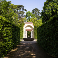 Schloss und Schlossgarten Schwetzingen - Garten - Porzellanhaus / Wasserglocke - Von außen- Von Süden - Blick von der Querachse des Naturtheaters auf die Wasserglocke (den Brunnen) sowie auf das Porzellanhaus (Porzellanhaus: Grundfläche ca. 9 x 9 Meter; Bauzeit: 1762-1764; Architekt: Nicolas de Pigage) (aufgenommen im April 2024, um die Mittagszeit)