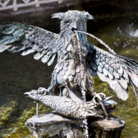 Schloss und Schlossgarten Schwetzingen - Garten - Wasserspeiende Vögel - Bassin - Von Südost - Blick in das Bassin, in der Mitte die Skulptur eines Uhus auf einem Holzstumpf, in den Fängen ein toter Fasan (Originale Skulptur: Herkunft vermutlich von Schloss La Malgrange bei Nancy, Datierung wohl um 1740, Kunstschmied unbekannt, Material / Fassung aus Eisenblech mit realistischer Bemalung; Kopie: um 1933 kopiert, 1995 erneut kopiert, nun mittels Kupferblech) (aufgenommen im April 2024, am Nachmittag)